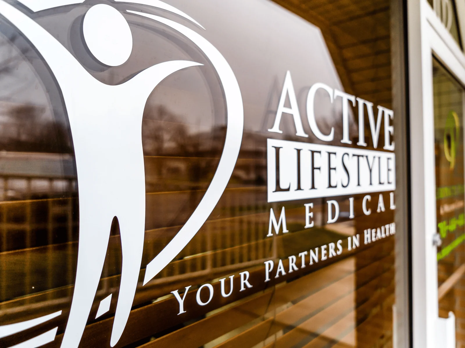 Active Lifestyle Medical window signage reading Your Partners In Health