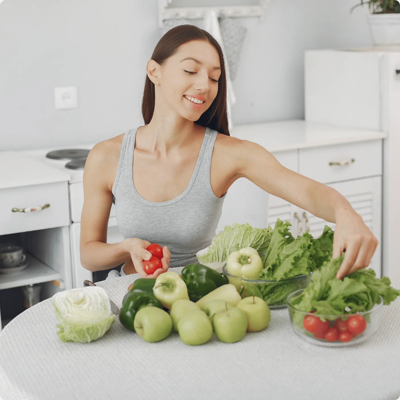 Woman arranging fresh vegetables on a bright kitchen counter